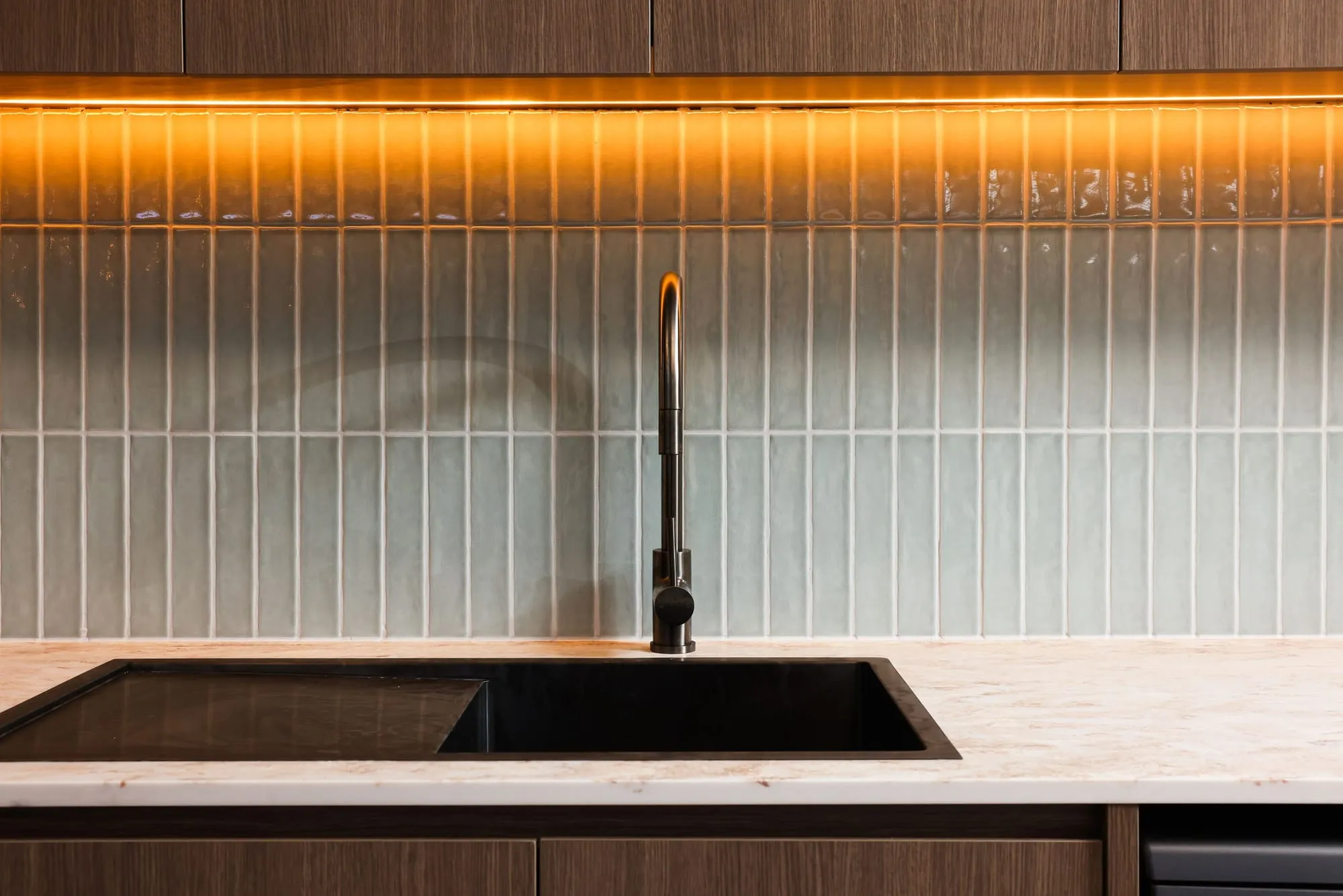 Kitchen with tiled splashback and warm lighting at HelpAhead, Caringbah