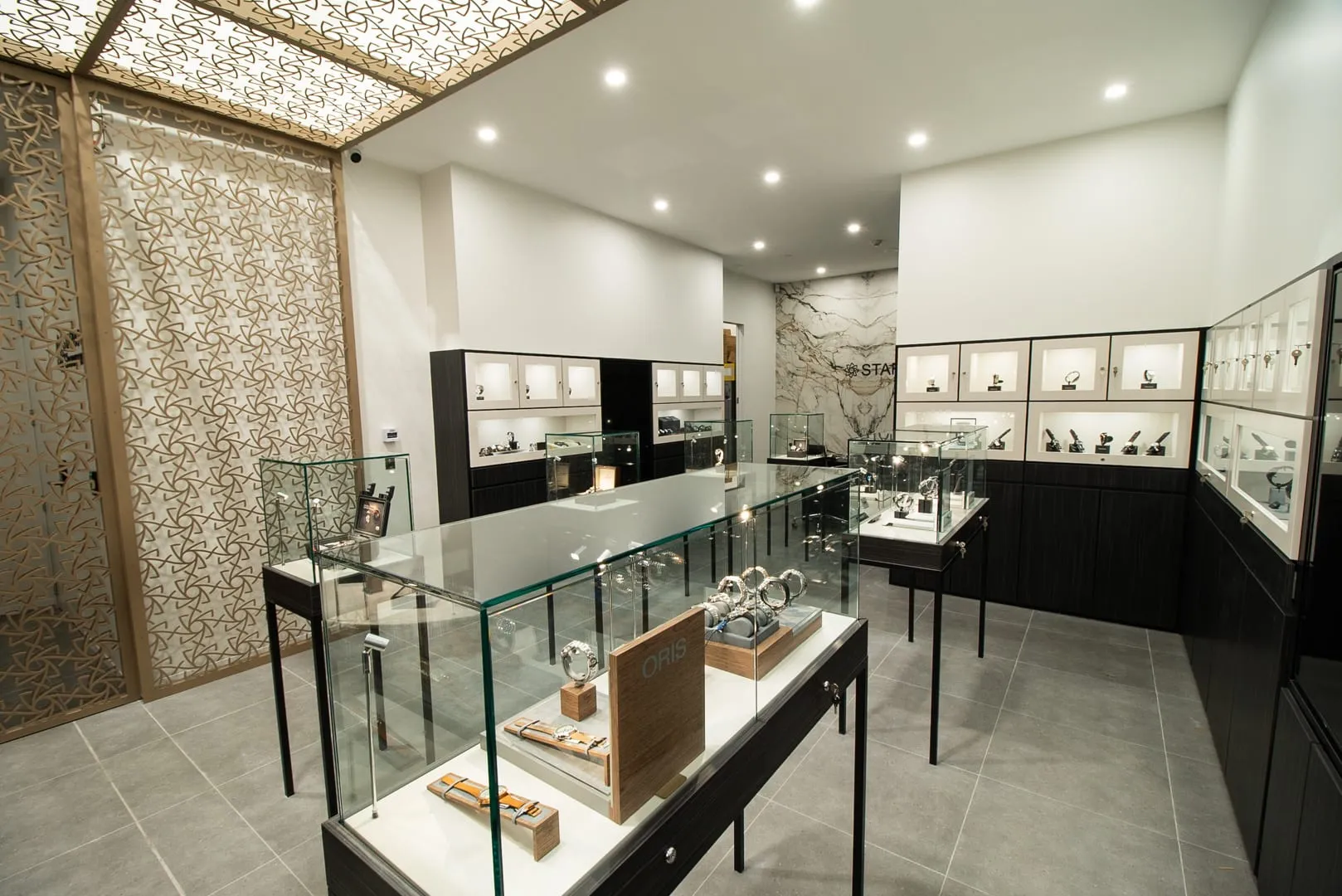 Glass display cases and backlit wall cabinets at Starbuy, Alexandria