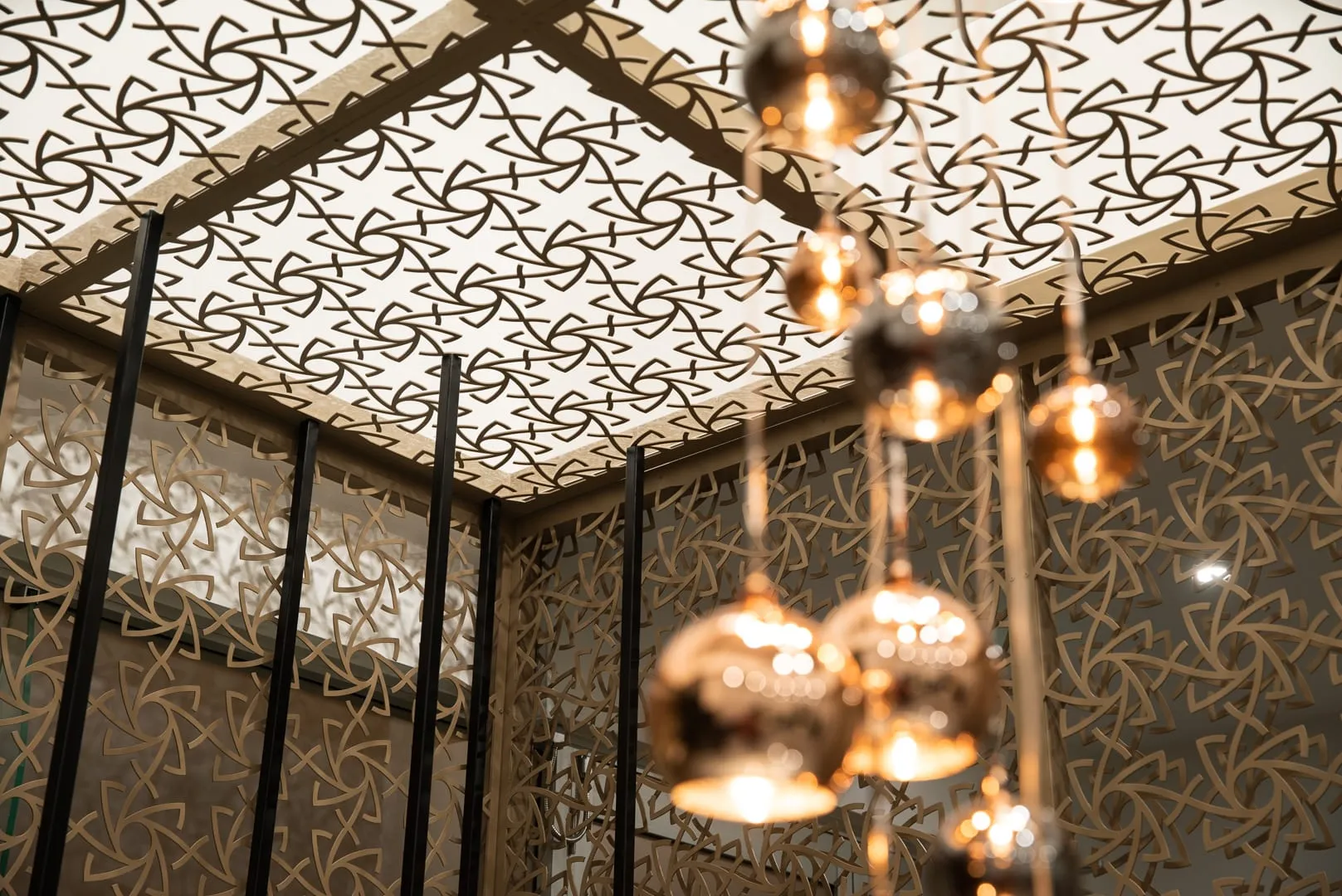 Decorative screen ceiling with cluster of copper pendants at Starbuy, Alexandria