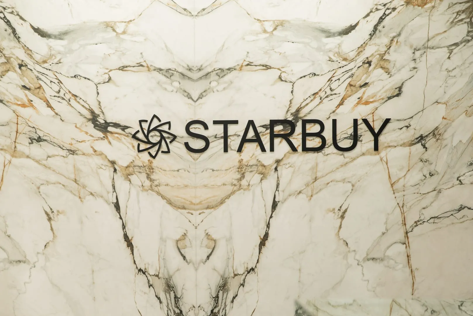 Starbuy logo on a marble feature wall in the Alexandria showroom